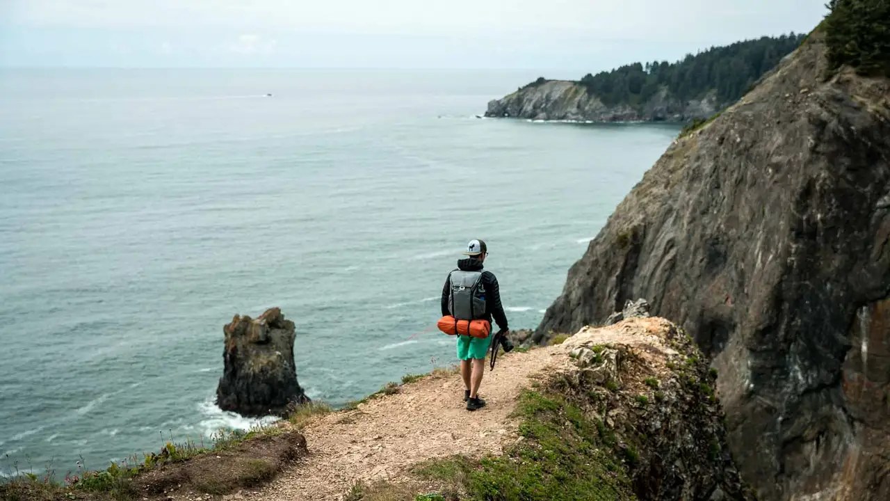 Close up on a plate of mashed potatoes, topped with baked pork chops with cream of mushroom soup, and a side of green beans.