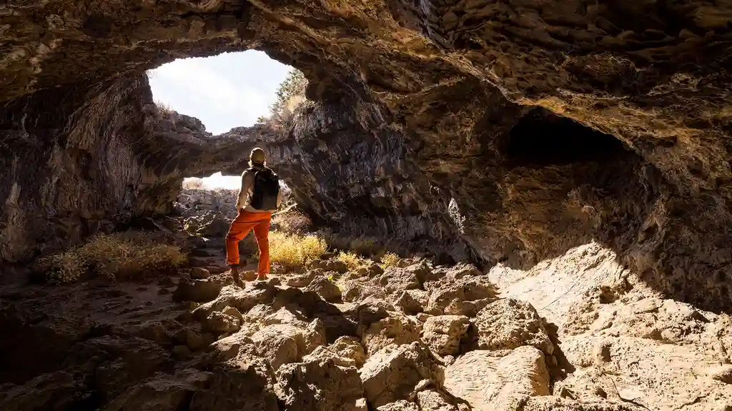 Close up on a plate of mashed potatoes, topped with baked pork chops with cream of mushroom soup, and a side of green beans.