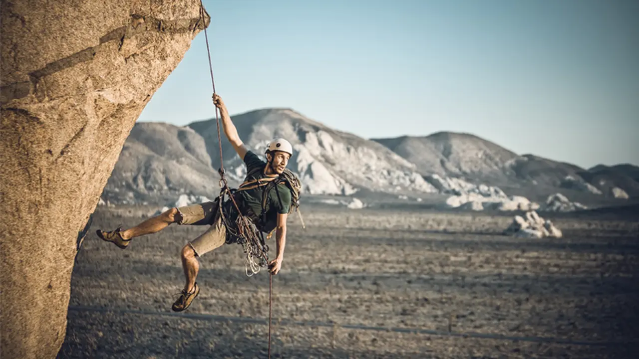 Close up on a plate of mashed potatoes, topped with baked pork chops with cream of mushroom soup, and a side of green beans.