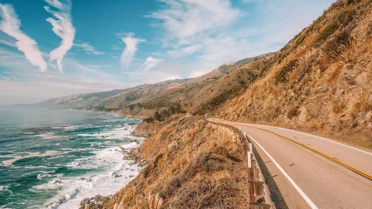 Close up on a plate of mashed potatoes, topped with baked pork chops with cream of mushroom soup, and a side of green beans.