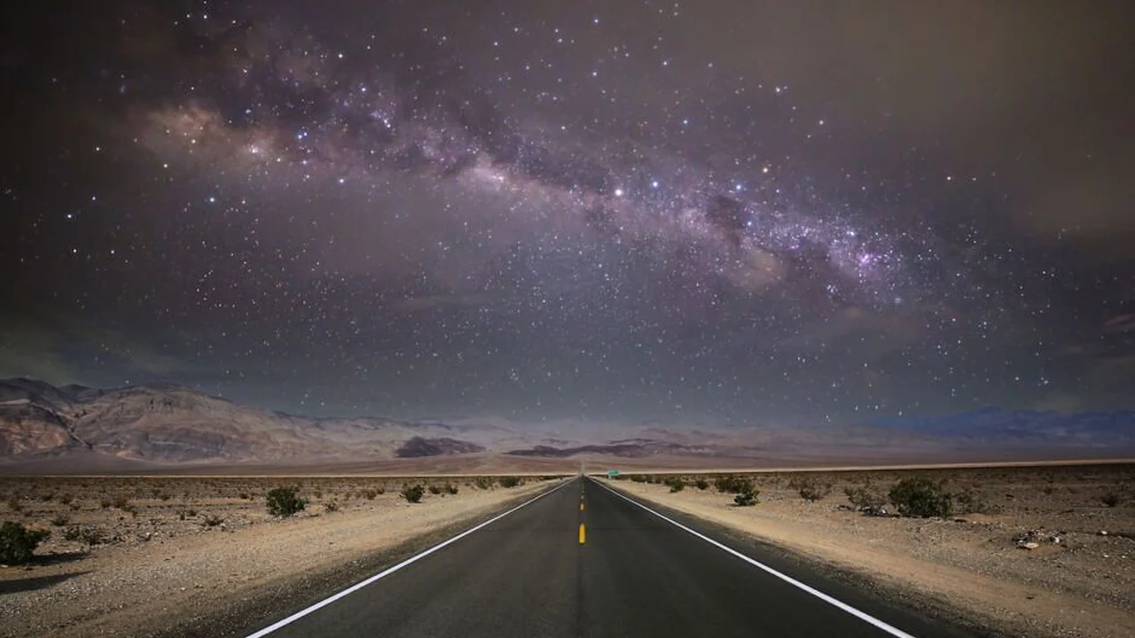 Close up on a plate of mashed potatoes, topped with baked pork chops with cream of mushroom soup, and a side of green beans.